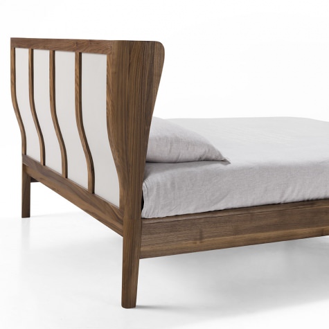 Upholstered bed in solid walnut