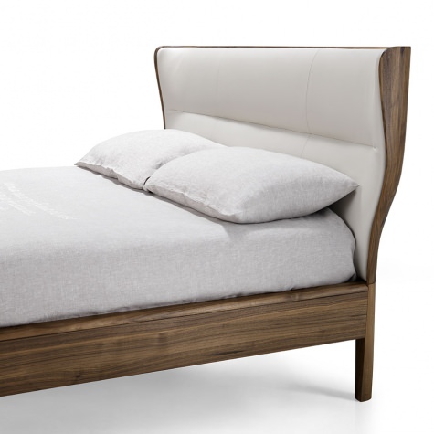 Upholstered bed in solid walnut